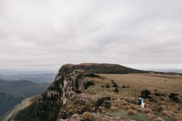 Dramatic vista of a mountain cliff with an overcast sky in Cambará do Sul, perfect for travel imagery.